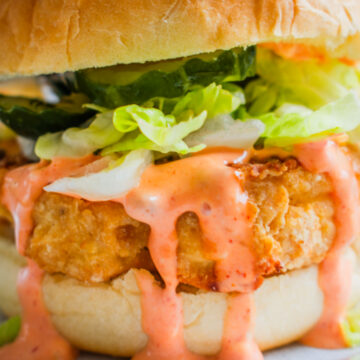 Crispy KFC Kentucky Fried Cauliflower Sandwich with fresh toppings like Lettuce, Pickles and spicy topping on a bun