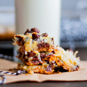 Magic cookie bars in front of a big glass of milk