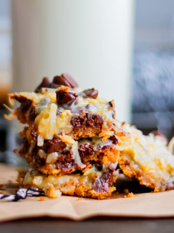 Magic cookie bars in front of a big glass of milk