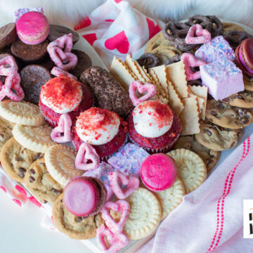 Valentine’s Day graze board with heart-shaped pretzels, cookies, fresh fruit, cheese, and chocolate.