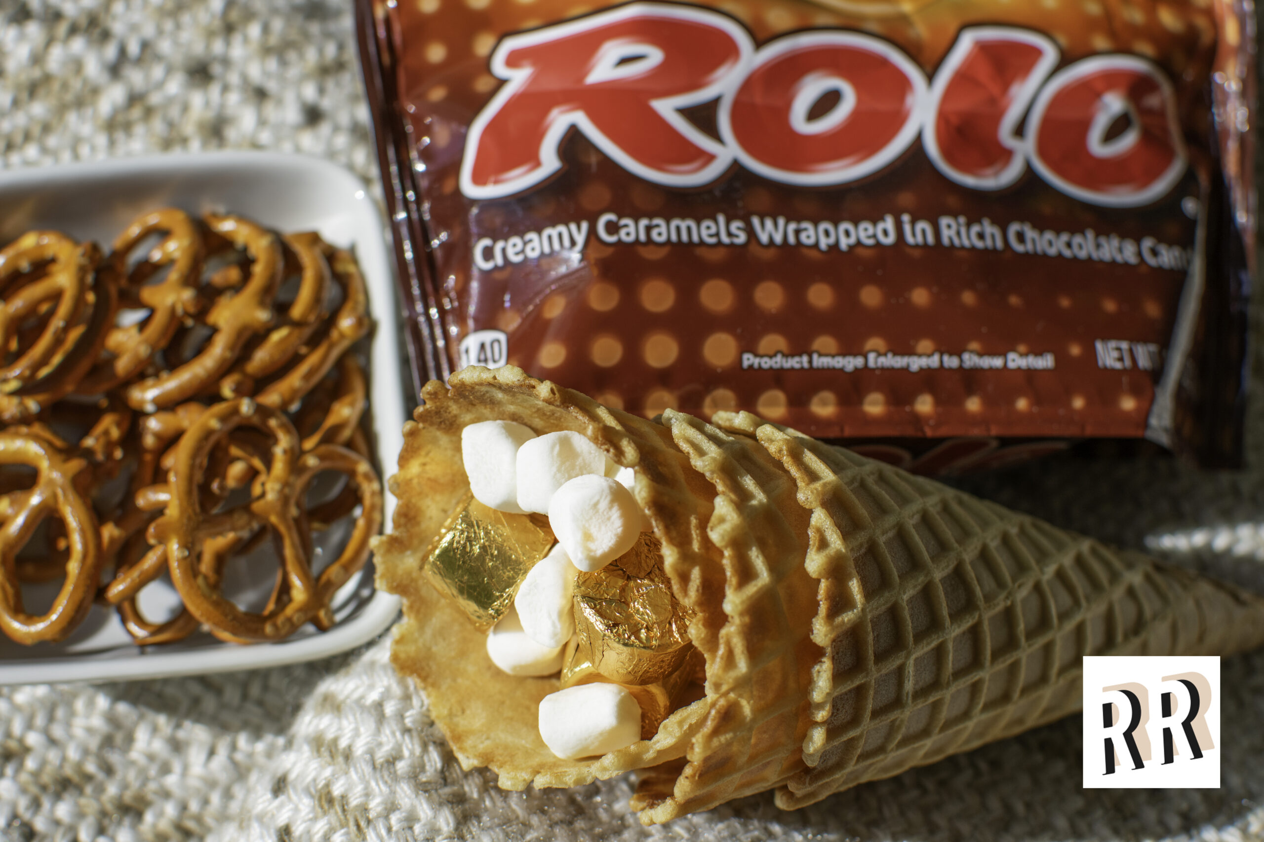 Hershey's Loaded Smores in a Cone. Pretzels, rolo caramels, marshmallows, and crushed graham cracker for campfire in a cone vibes