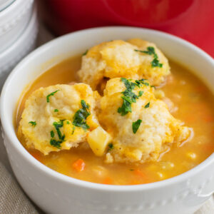 Cozy bowl of Chickpea Dumpling Soup with fluffy dumplings and creamy vegetable broth pinterest pin