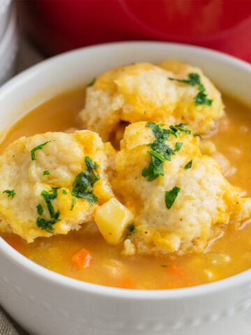 Cozy bowl of Chickpea Dumpling Soup with fluffy dumplings and creamy vegetable broth pinterest pin