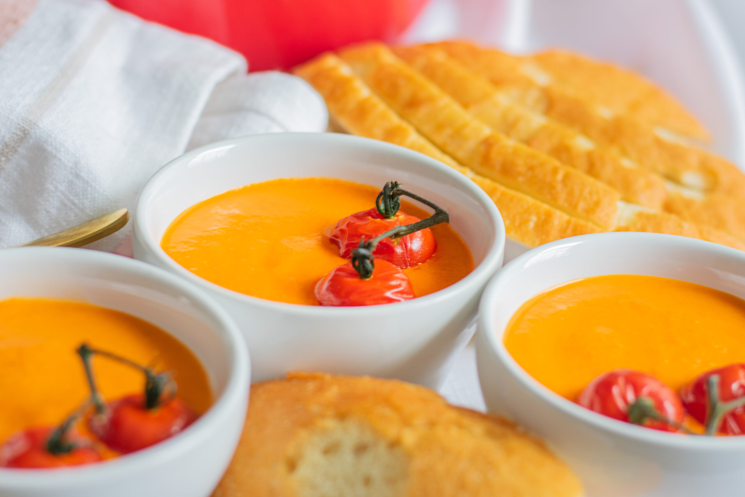 Delicious homemade roasted tomato soup served with crusty bread, topped with fresh herbs and a swirl of cream—perfect for cozy meals and comfort food lovers.