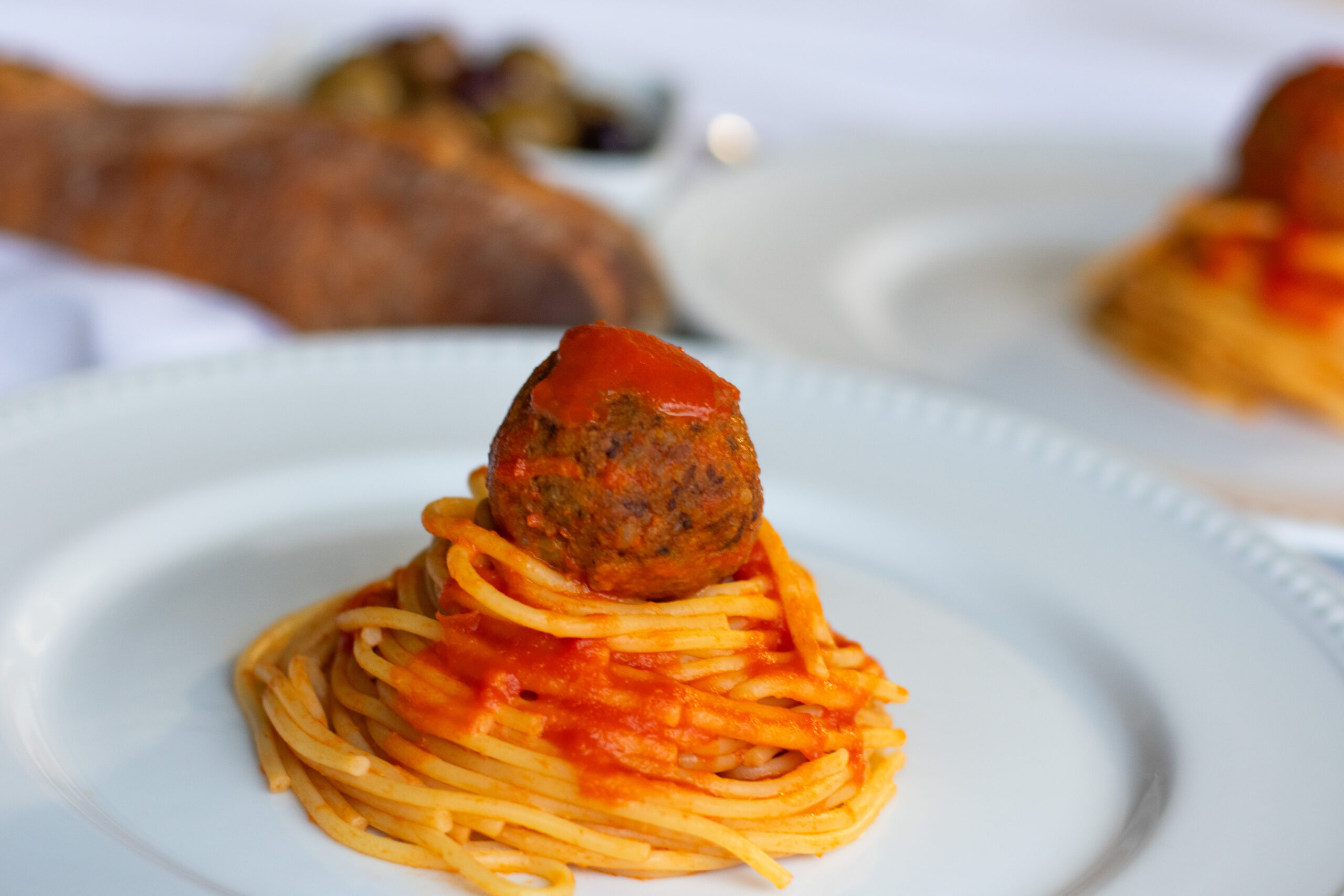 Vegetarian Meatballs and Spaghetti piled high on a white plate