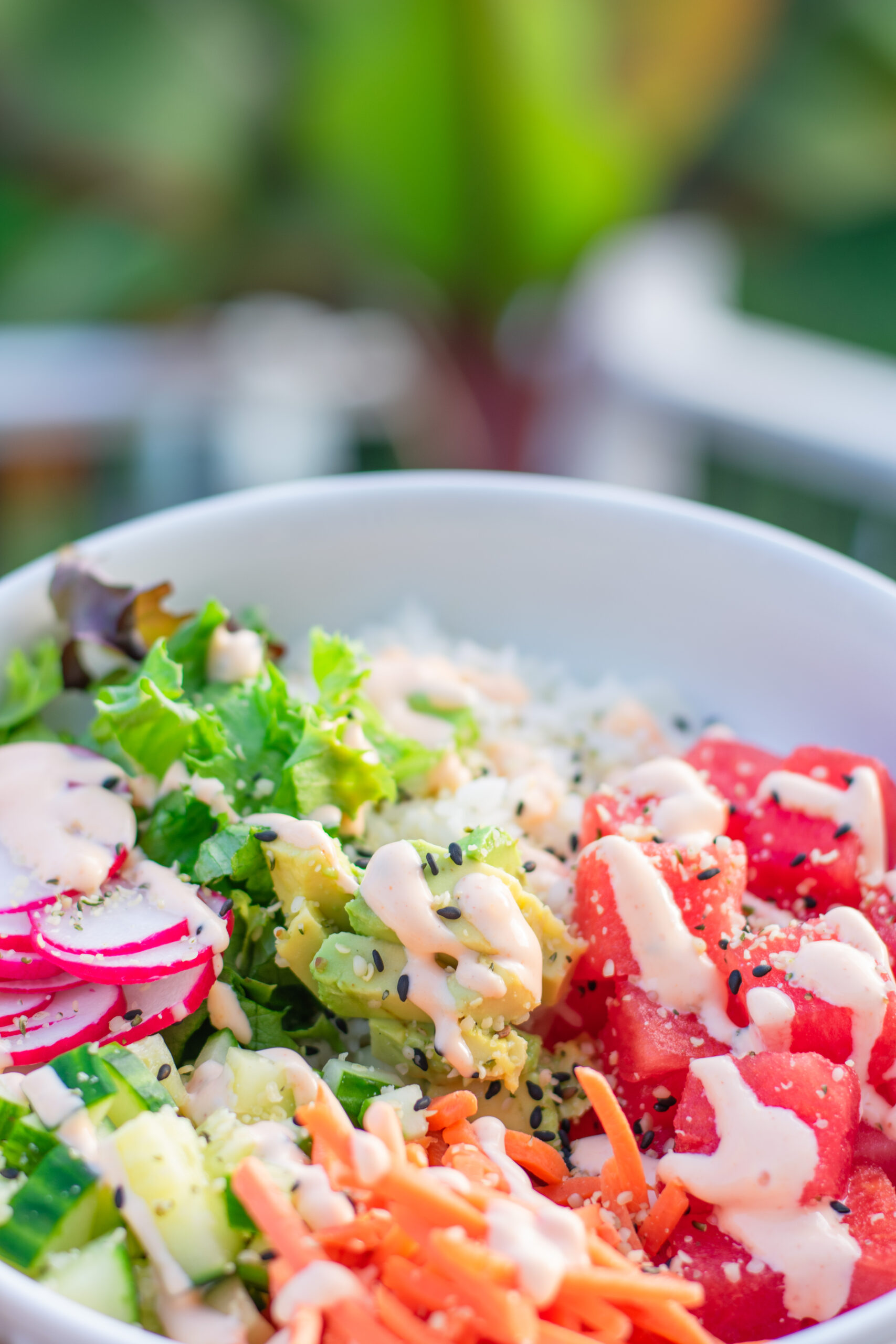 Zoomed-in view of vibrant plant-based poke bowl with tropical ingredients and fresh vegetables