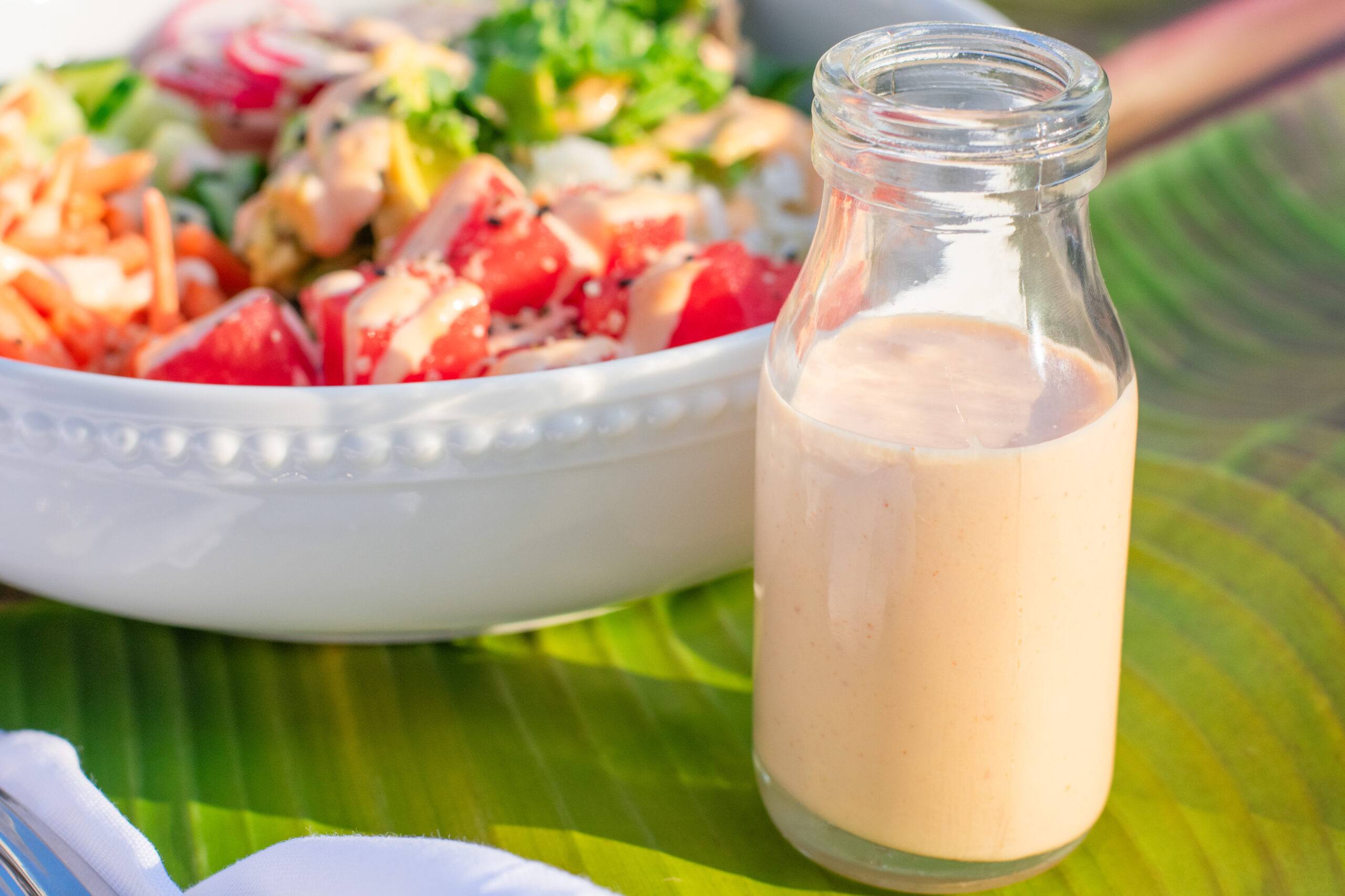 Close-up of vibrant watermelon poke bowl with fresh veggies and a drizzle of spicy mayo for a bold, refreshing vegetarian meal