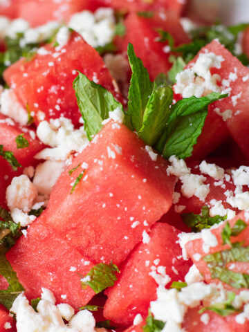 Detailed close-up of sweet and salty watermelon salad with feta and mint