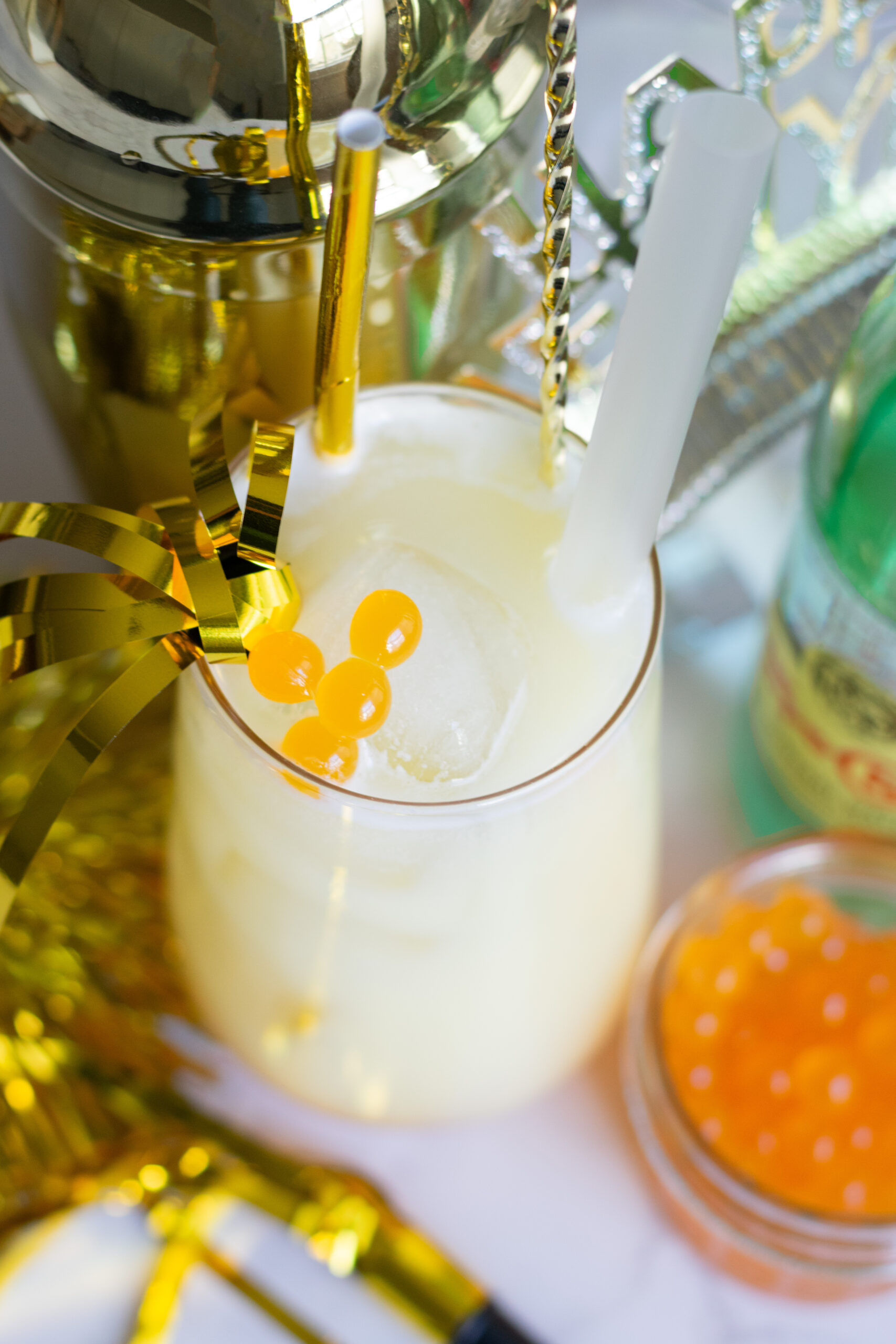Tropical mango coconut popping boba mocktail with ice and bubbles