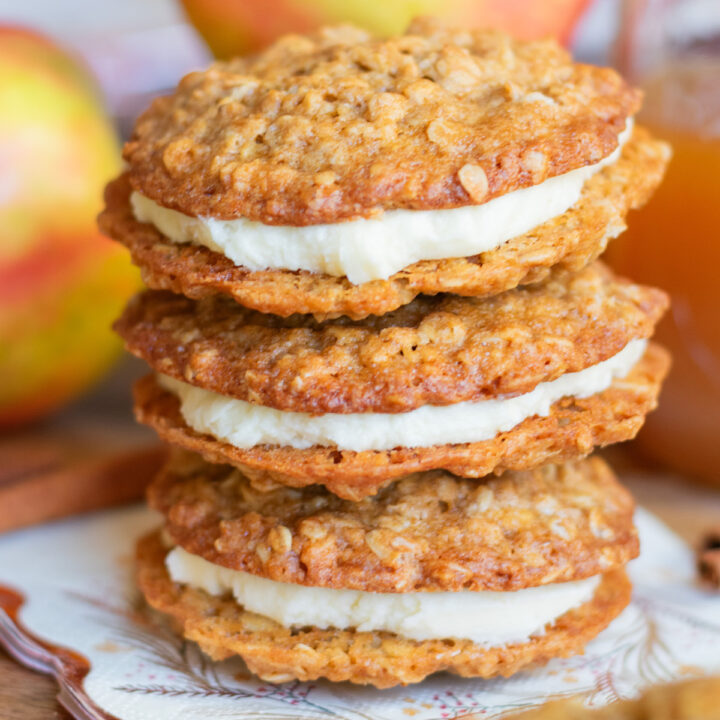 Stacked apple cider oatmeal cream pies made with soft oatmeal cookies and fluffy cream filling
