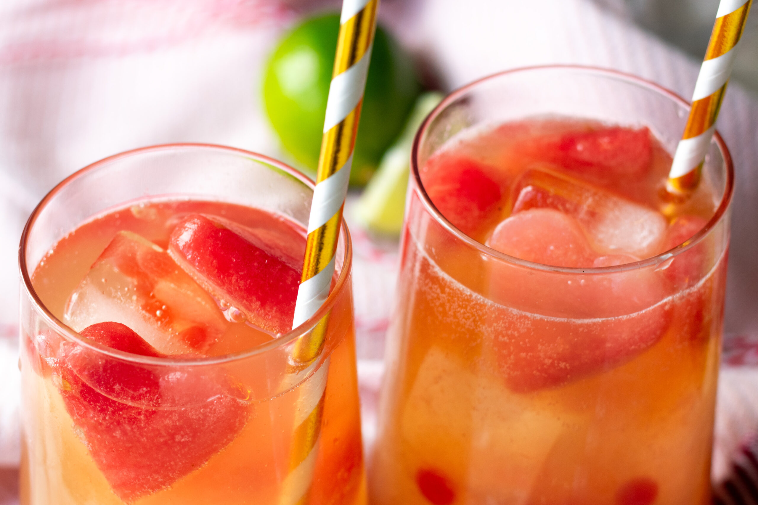 Pink popping boba mocktail with watermelon heart ice cubes and fizzy bubbles