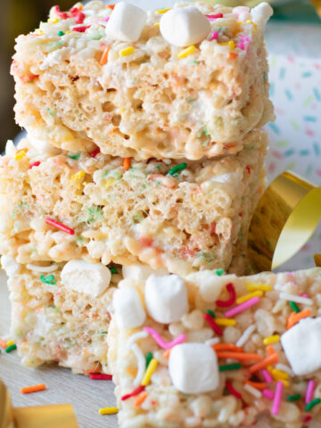 Birthday Cake Rice Krispie Treats stacked with colorful sprinkles and mini marshmallows