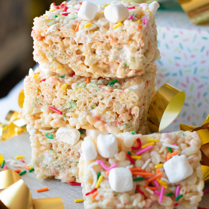 Birthday Cake Rice Krispie Treats stacked with colorful sprinkles and mini marshmallows
